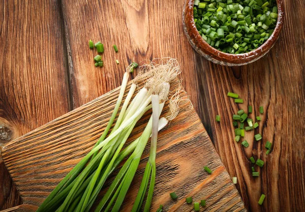 Cebolla verde sobre tabla de madera —  Fotos de Stock