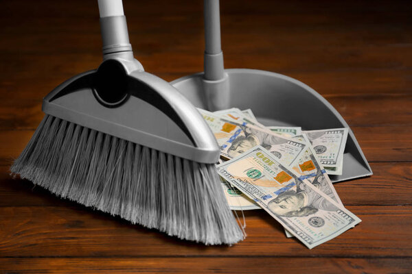 Broom sweeping dollars