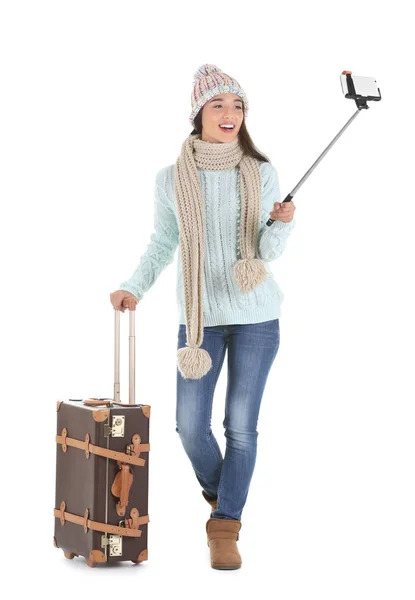 Tourist in warm clothes taking selfie — Stock Photo, Image