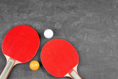 Ping pong rackets and balls on grey background clipart