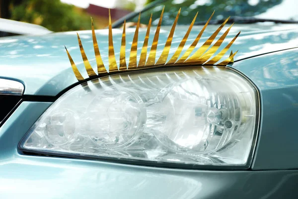 Car with eyelashes on headlight — Stock Photo, Image