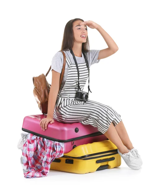 Attractive tourist sitting on suitcase — Stock Photo, Image