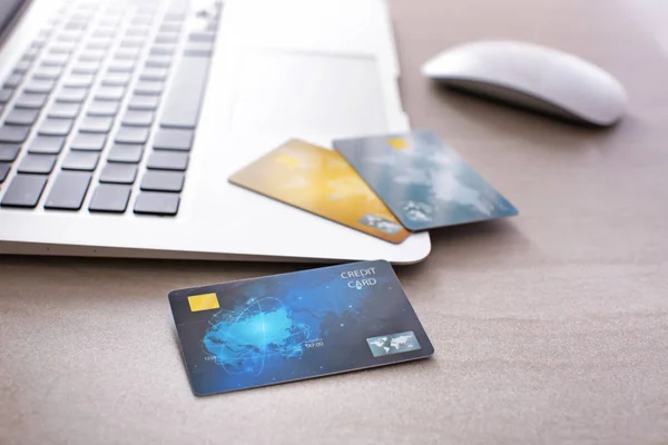 Credit cards and laptop on table, closeup — Stock Photo, Image