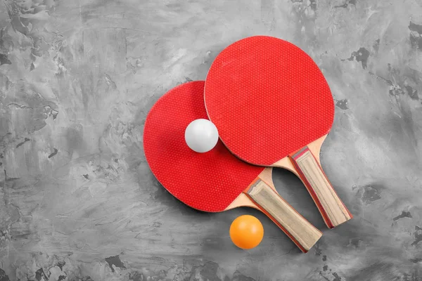 Ping pong raketleri ve topları gri arka plan üzerinde — Stok fotoğraf