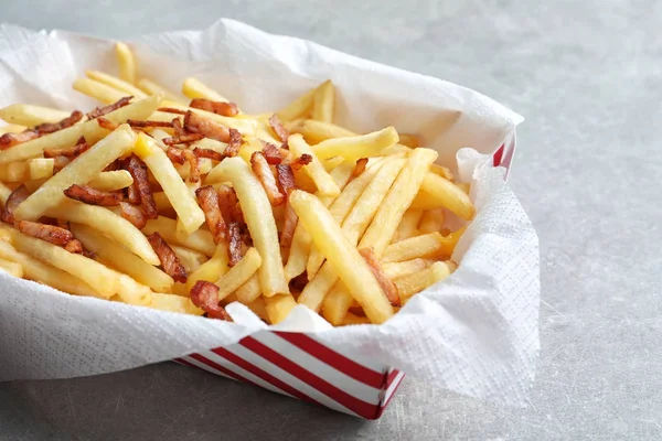 Box with french fries and bacon — Stock Photo, Image