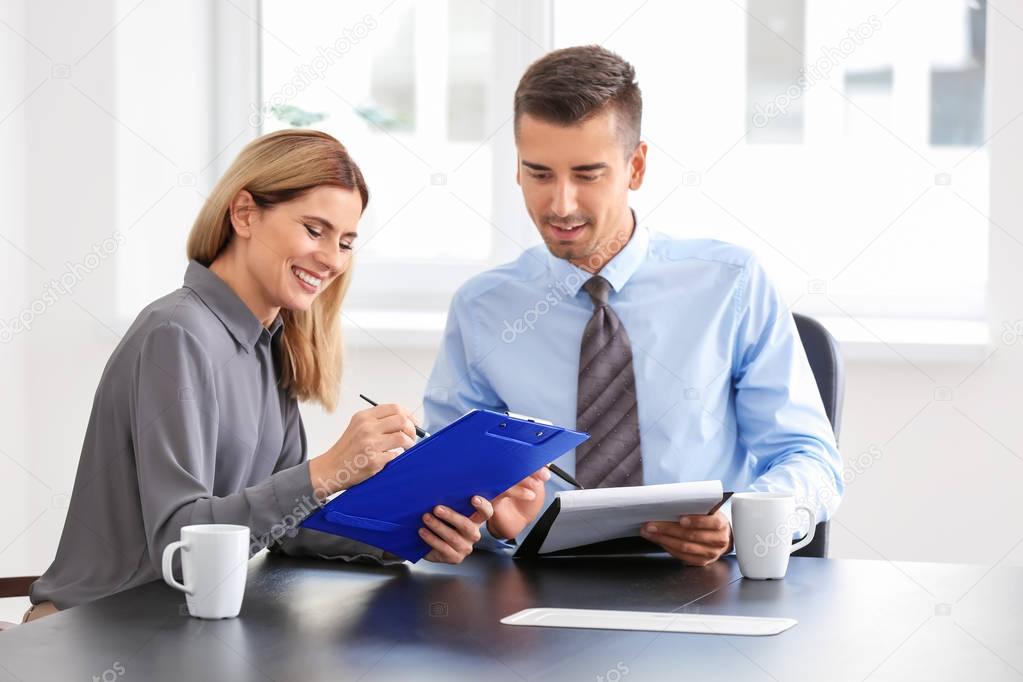 Young woman consulting man 