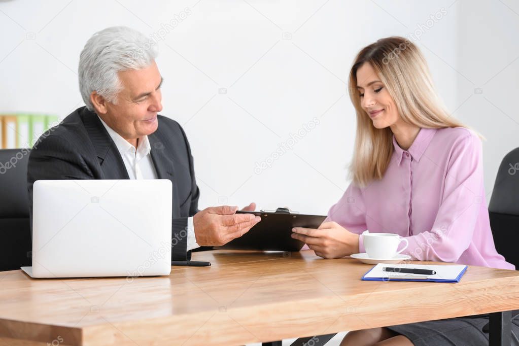woman consulting elderly man 