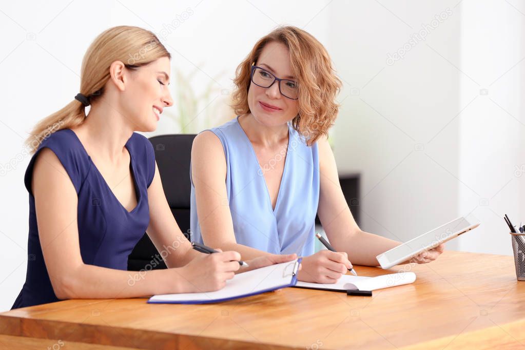 Young woman consulting customer in office