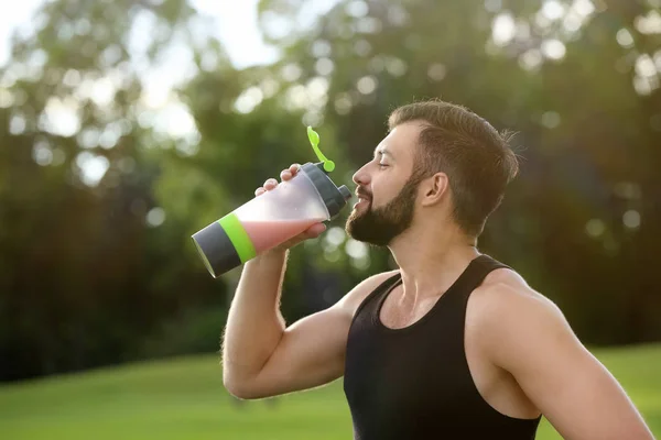 Sportos fiatal ember iszik fehérje megráz szabadban — Stock Fotó