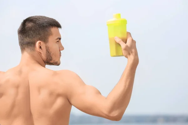 Joven guapo con batido de proteínas — Foto de Stock