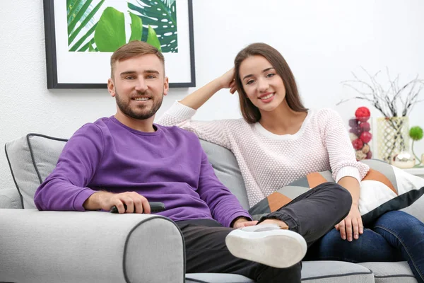 Young couple on sofa at home — Stock Photo, Image