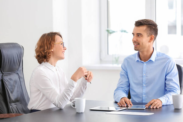 Young woman consulting man in office
