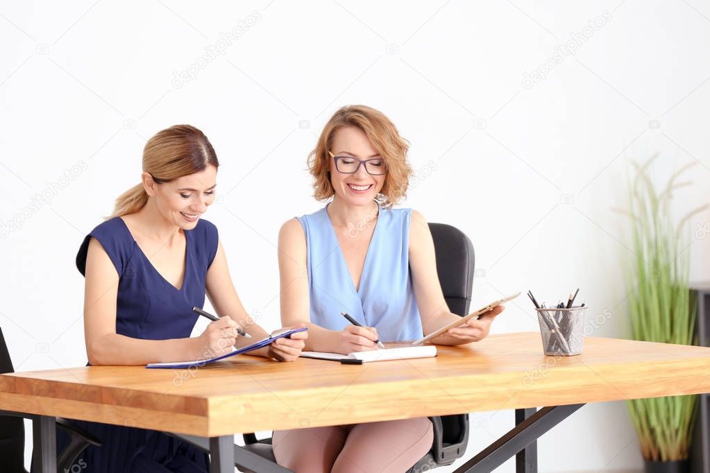 Young woman consulting customer in office