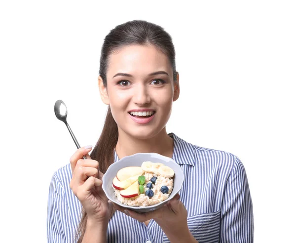 Молода жінка їсть вівсянку — стокове фото