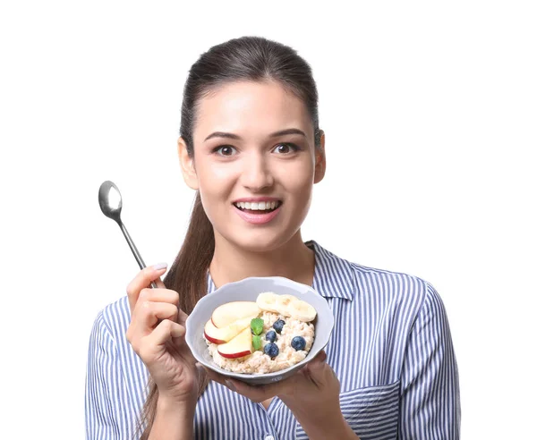 Young woman eating oatmeal — Stock Photo, Image