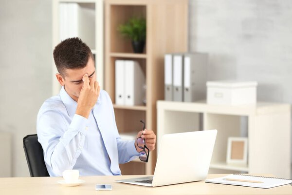 Tired man with laptop