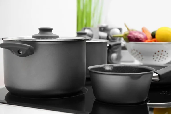 Cooking utensils on electric stove — Stock Photo, Image