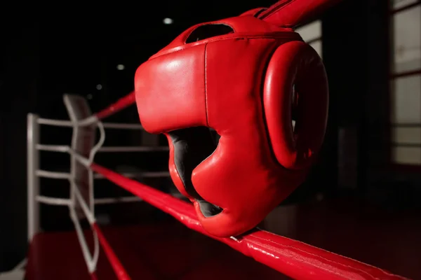 Headgear on ropes of boxing ring in gym — Stock Photo, Image