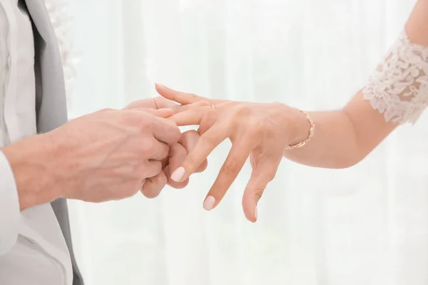 Жених надевает кольцо на палец невесты, крупным планом — стоковое фото