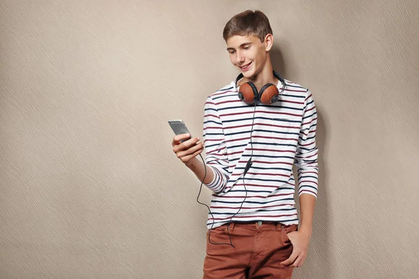 Teenager boy with headphones and mobile phone Stock Picture