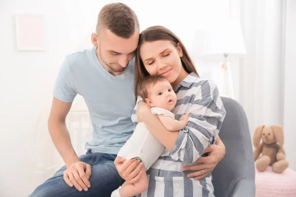 Happy young family with cute baby at home — Stock Photo, Image