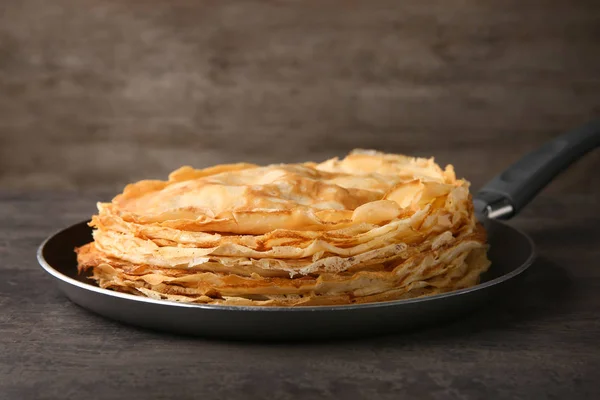 Frying pan with stack of delicious thin pancakes — Stock Photo, Image