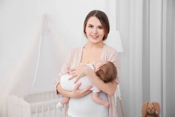 Ibu muda menggendong bayi di rumah — Stok Foto