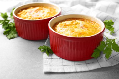 Ramekins with corn pudding on table clipart