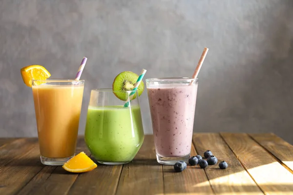 Different milkshakes in glasses on table — Stock Photo, Image