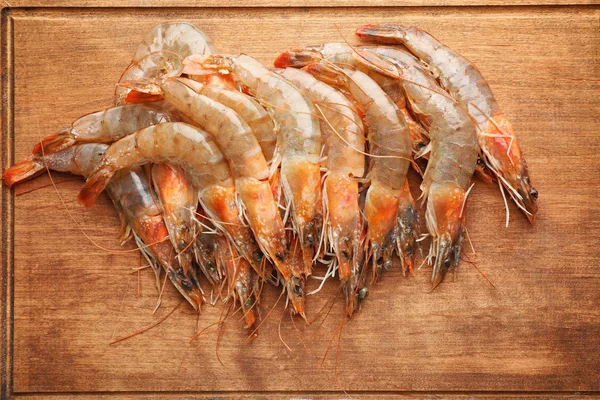 Fresh shrimps on wooden board — Stock Photo, Image