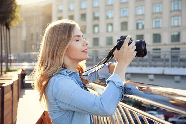 Young female tourist taking photo outdoors — Stock Photo, Image