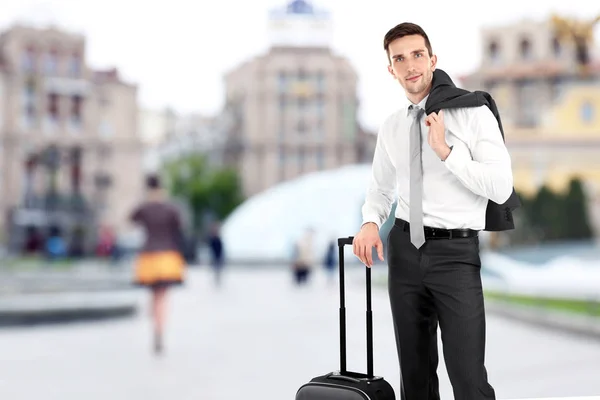 Молодой бизнесмен с багажом на открытом воздухе — стоковое фото