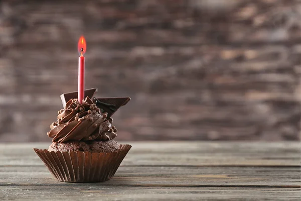 Tasty chocolate cupcake with candle — Stock Photo, Image