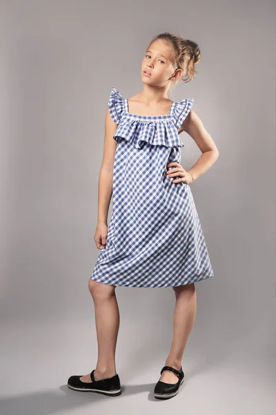 Little fashionable girl on grey background — Stock Photo, Image