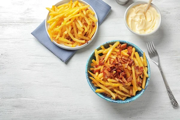 Dishware with french fries and bacon — Stock Photo, Image