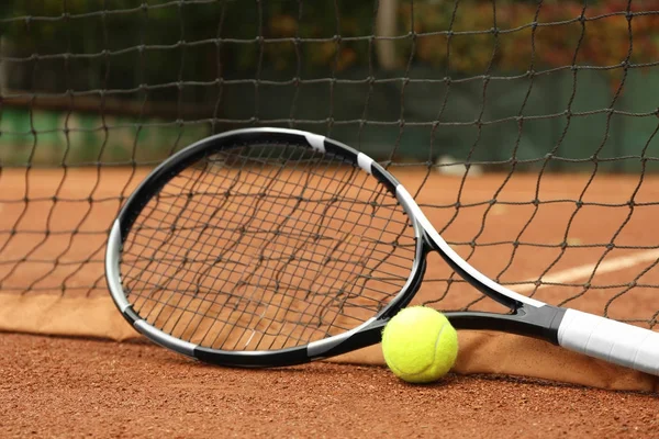 Tennis racket and ball on court — Stock Photo, Image