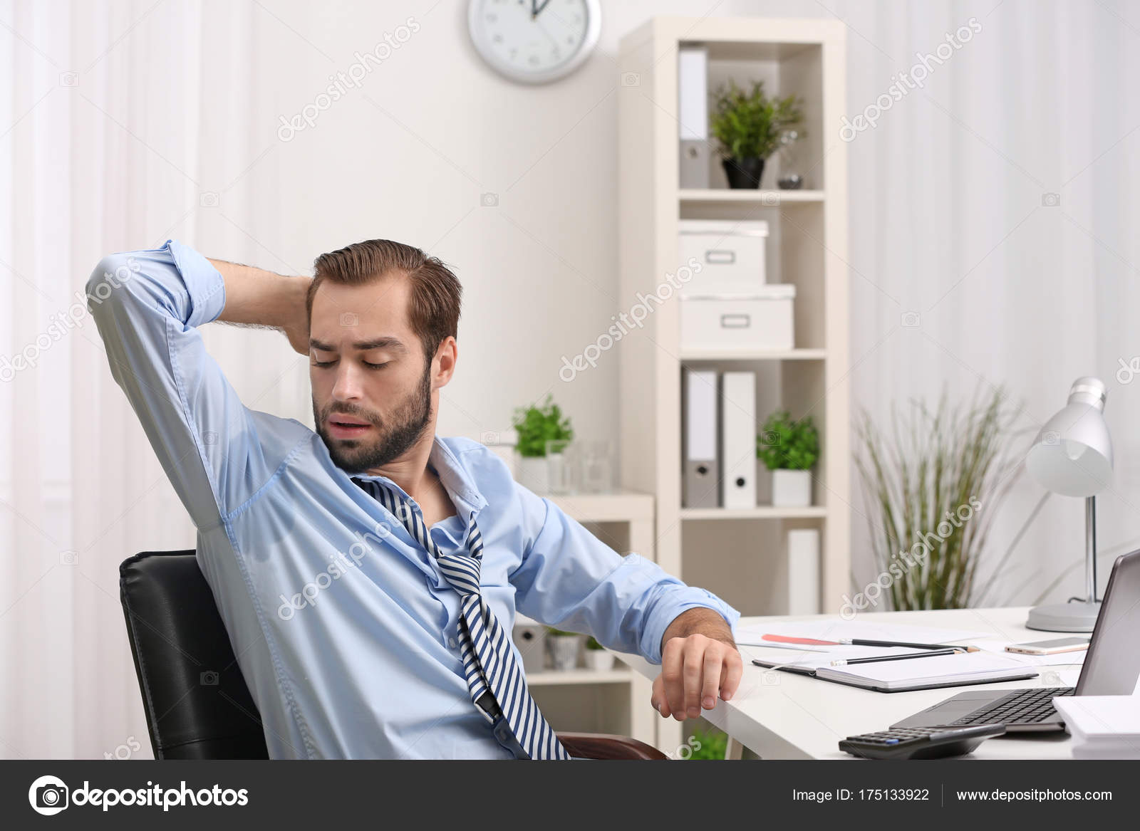 Man sweating in office Stock Photo by ??belchonock 175133922