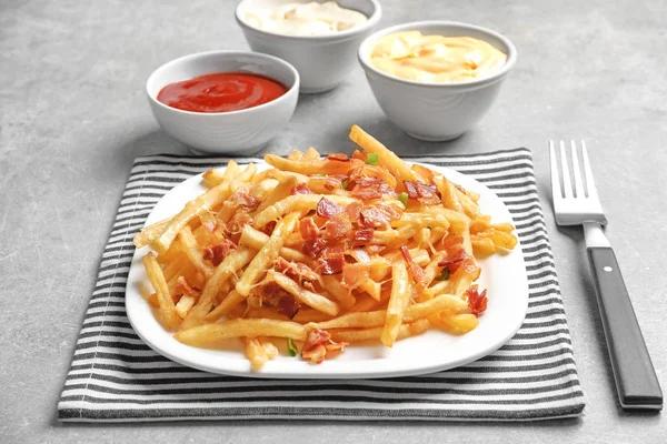 Plate with french fries and bacon — Stock Photo, Image