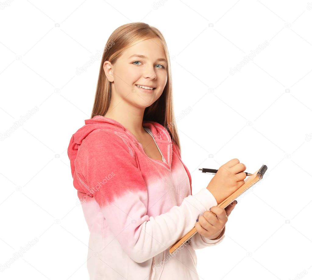 Cute teenager girl making notes on white background