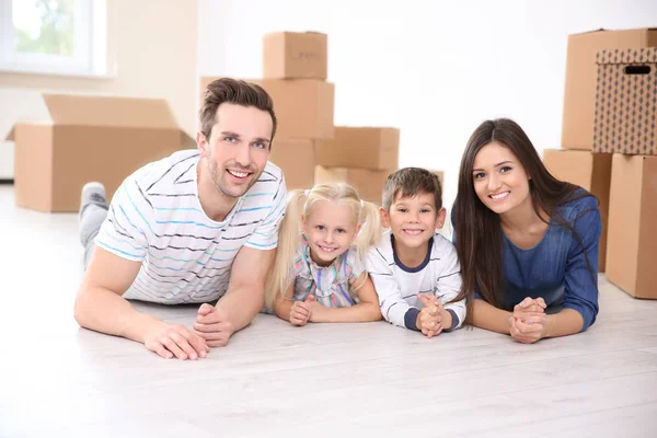 Familie liegt in ihrem neuen Zuhause auf dem Boden — Stockfoto