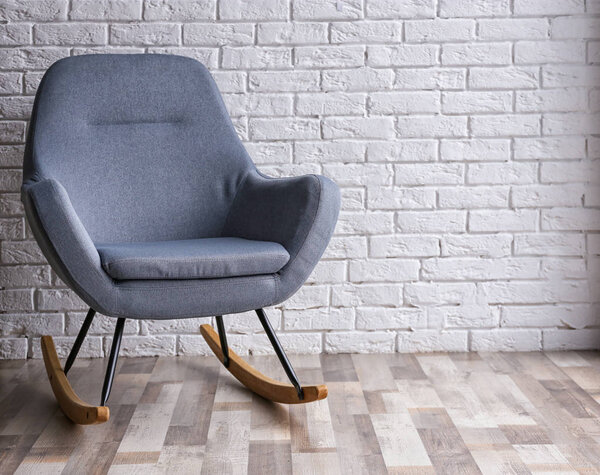 armchair against brick wall