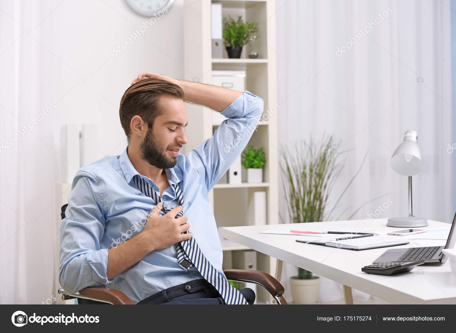 Man sweating in office Stock Photo by ©belchonock 175175274