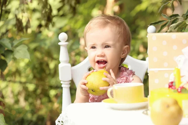 Cute baby at festive table outdoors — Stock Photo, Image