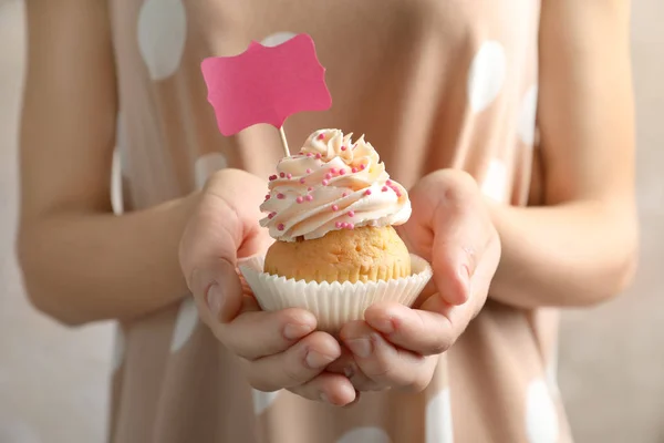 Woman holding delicious cupcake — Stock Photo, Image