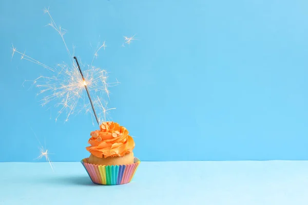Tasty cupcake with sparkler — Stock Photo, Image