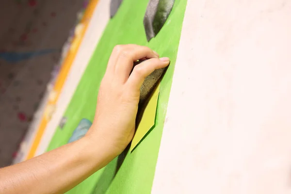 Hand of young woman exercising in climbing gym — Stock Photo, Image