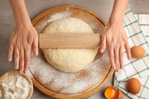 Female chef rolling dough — Stock Photo, Image