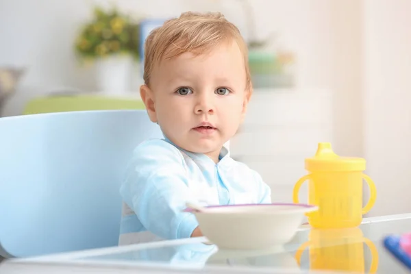 Adorable baby sitting at table indoors — Stock Photo, Image