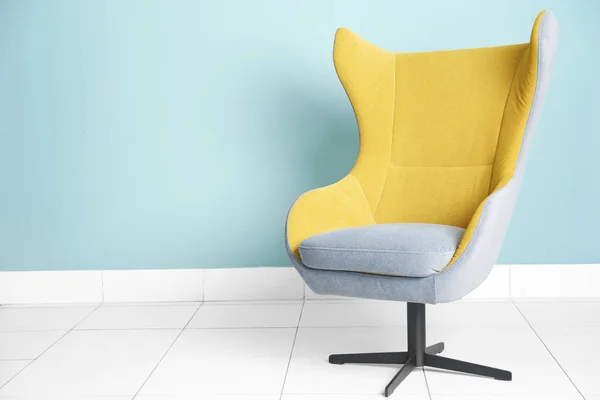 Armchair against blue wall — Stock Photo, Image