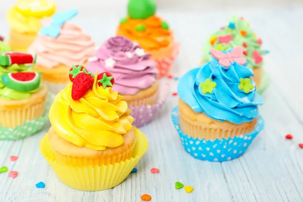 Beautiful cupcakes on wooden table — Stock Photo, Image